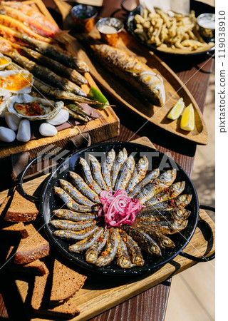 Delicious seafood assortment featuring grilled fish, sardines, oysters. Perfect for gourmet dinner Delicious seafood assortment featuring grilled fish, sardines, oysters. Perfect for gourmet dinner 119038910