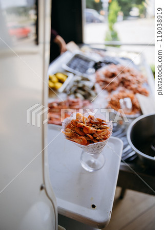 Fresh shrimp in a cone served at a seafood market. Perfect for seafood promotions 119038919