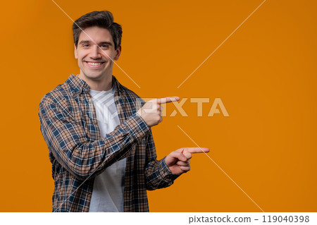 Recommending smiling man pointing at right side, copy space or advertising. 119040398