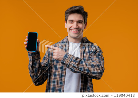 Excited smiling man, online shopping consumer. Mobile phone, smartphone mockup with copy space screen for your advertisement Excited smiling man, online shopping consumer. Mobile phone, smartphone mockup with copy space screen for your advertisement 119040418