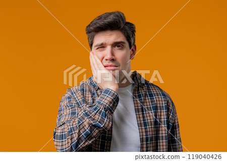 Mature Man suffering With Toothache On Yellow Studio. Jaw ill, oral pain, dental 119040426