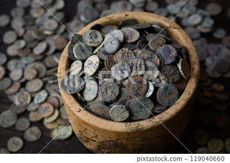 Ancient Roman coin hoard, lot of old money in wooden pot and pile on table, vintage background. Concept of Rome, antique, Empire, texture 119040660