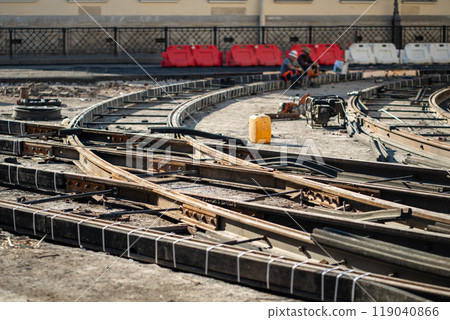 Major tram track overhaul on closed city street. Rail junction with beams, tools awaiting completion Major tram track overhaul on closed city street. Rail junction with beams, tools awaiting completion 119040866
