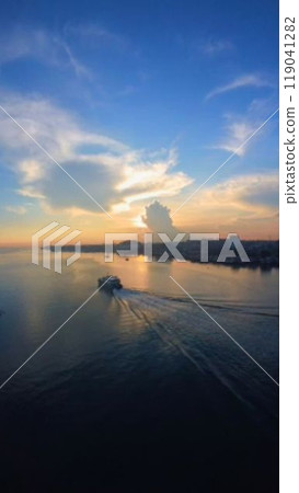 A small boat heading to the fishing grounds as the sun rises 119041282