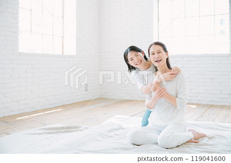 Parents and children relaxing together in the living room Parents and children relaxing together in the living room 119041600