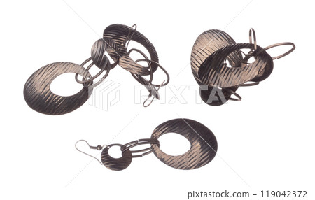 Fashion gold Earrings with beautiful work detail is value. Luxury golden earring is fashion trend and fly in air. White background isolated 119042372