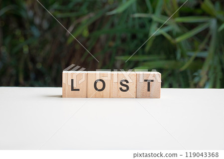 Lost, word on top of white table. Lost, word on top of white table. 119043368