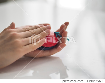 Child's hands playing castanets 119043569