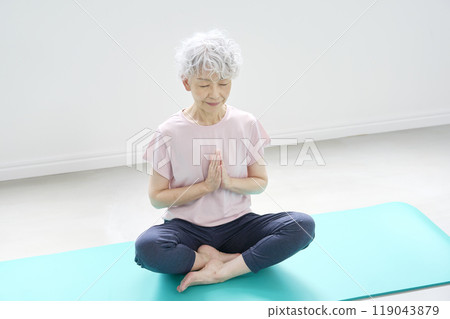 Senior woman doing yoga meditation Senior woman doing yoga meditation 119043879