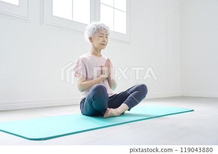 Senior woman doing yoga meditation Senior woman doing yoga meditation 119043880