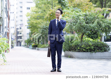 Business, outdoor, middle-aged man making a phone call 119044736