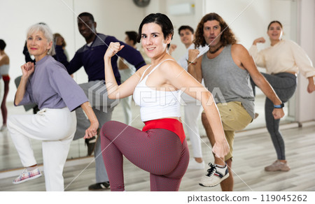 Happy Latina enjoying active dancing during group training Happy Latina enjoying active dancing during group training 119045262