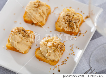 Four hummus sandwiches are laid out on plate - traditional snack of Middle East. 119045372