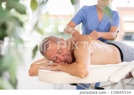 male patient having massage male patient having massage 119045534