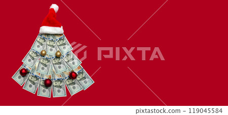 Christmas tree made of 100 dollar bills on a red background, Christmas decoration of finances, expenses, savings in the new year. Copyspace, banner 119045584