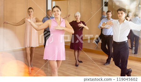 Young girl learning to dance kizomba in dancing class 119045602