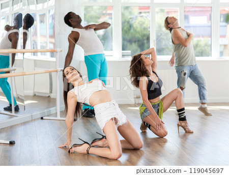 Women performing high heels choreography during group dance class 119045697