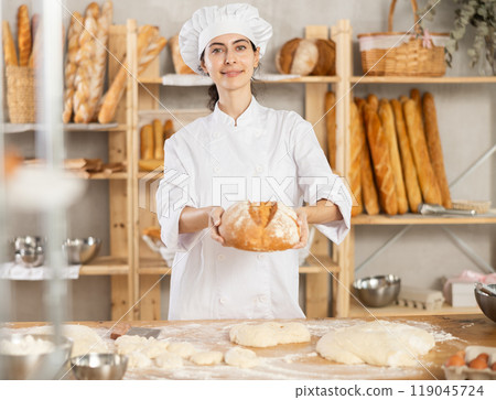 Young female baker with homemade bread Young female baker with homemade bread 119045724