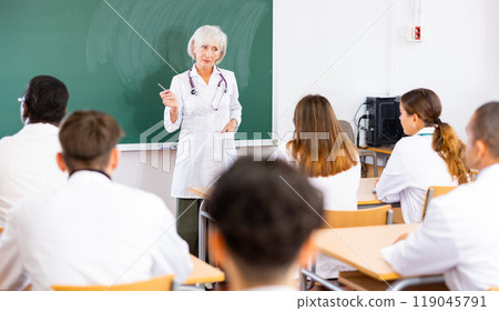 Professor reading lecture to group of medical students Professor reading lecture to group of medical students 119045791