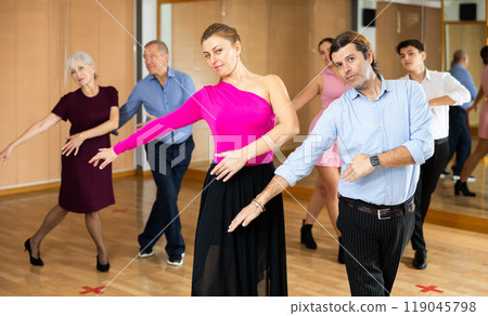 Woman and man practicing vigorous jitterbug in dance class 119045798