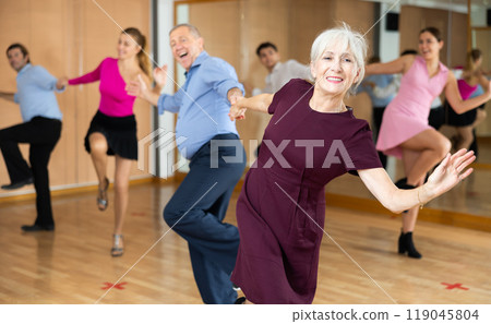 Elderly pair practicing Latino dance in dance studio 119045804
