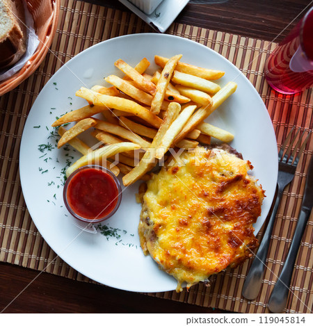 Veal Orloff served with fried potatoes and tomato sauce 119045814