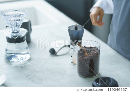 A young female sales clerk brewing coffee on a weekend morning A young female sales clerk brewing coffee on a weekend morning 119046367