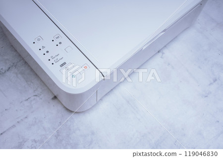 White printer for printing and scanning documents, close-up on a marble table. White printer for printing and scanning documents, close-up on a marble table. 119046830