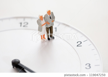 Senior life Image of old age Clock face and miniature of senior couple Senior life Image of old age Clock face and miniature of senior couple 119047250