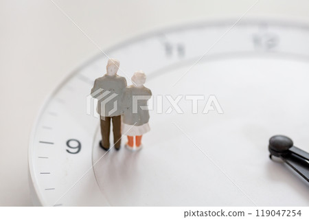 Senior life Image of old age Clock face and miniature of senior couple 119047254