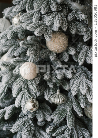 Christmas tree with many ornaments on it Christmas tree with many ornaments on it 119050993