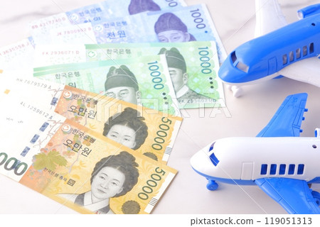 Image of traveling to Korea using Korean currency, Won KRW banknotes and airplanes Image of traveling to Korea using Korean currency, Won KRW banknotes and airplanes 119051313