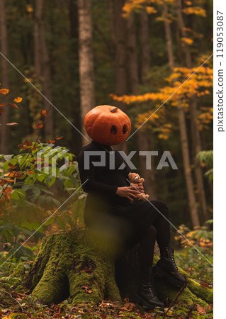 Surreal Pumpkin Head in Autumn Forest 119053087