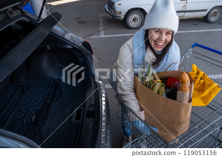 Woman uploading Groceries into Car Woman uploading Groceries into Car 119053156