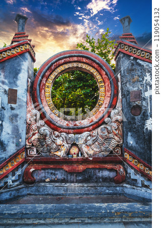 Beautiful Ancient Asian gate to Buddhist pagoda in Hoi An old town in Vietnam in Asia at sunset 119054132