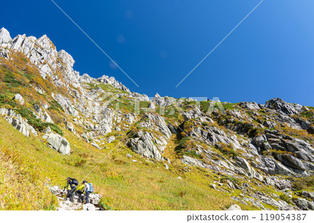 While climbing the Hacchozaka mountain trail to Senjojiki Cirque, I can see the sharp rock peaks with the climbers ahead of me. While climbing the Hacchozaka mountain trail to Senjojiki Cirque, I can see the sharp rock peaks with the climbers ahead of me. 119054387