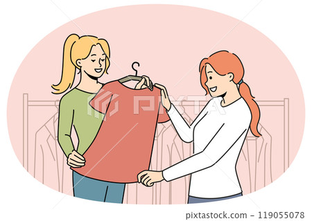 Smiling consultant help client with clothes choice Smiling consultant help client with clothes choice 119055078