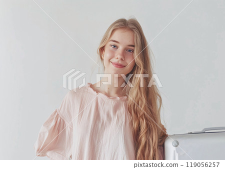 Young Woman with Suitcase Posing Cheerfully Against Plain Background Young Woman with Suitcase Posing Cheerfully Against Plain Background 119056257