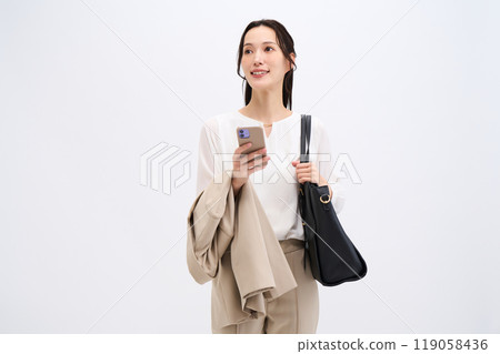 A businesswoman holds her jacket because it's hot 119058436