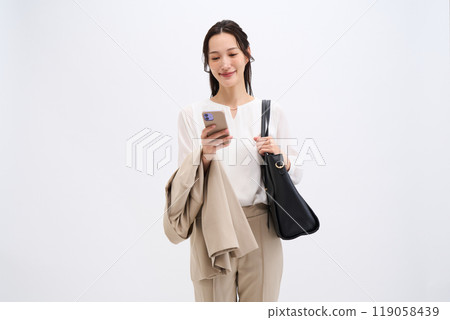 A businesswoman holds her jacket because it's hot A businesswoman holds her jacket because it's hot 119058439