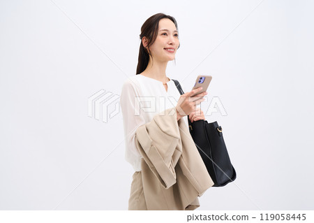 A businesswoman holds her jacket because it's hot 119058445