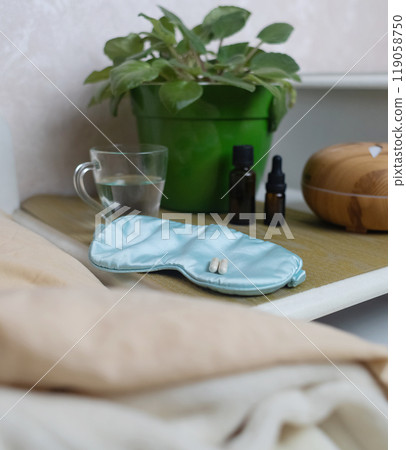 A woman cannot fall asleep and wants to drink a capsule with melatonin, a sleeping pill. Manifestations of jitlag or insomnia. Regulation of biological rhythms A woman cannot fall asleep and wants to drink a capsule with melatonin, a sleeping pill. Manifestations of jitlag or insomnia. Regulation of biological rhythms 119058750