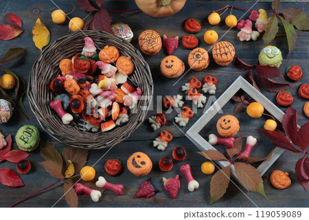 Wooden Halloween candy board. Holidays and Food. Dessert in shape of pumpkin, skull, witch.  119059089