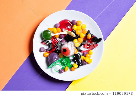 Assortment of Halloween candies on colorful background Assortment of Halloween candies on colorful background 119059178