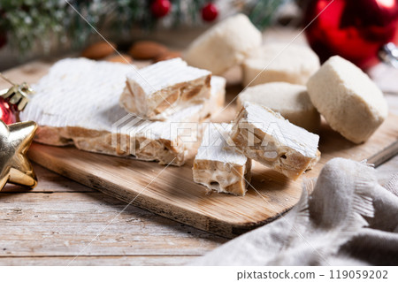 Christmas almond nougat and shortbread on wooden table 119059202