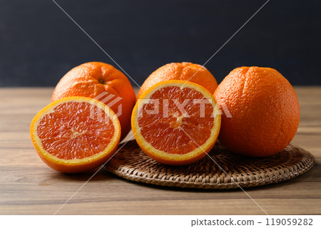 Caracara navel orange fruit on wooden table with black background Caracara navel orange fruit on wooden table with black background 119059282
