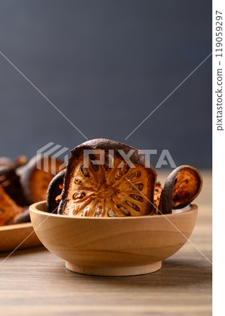Dried Bael fruit in wooden bowl, Herbal drink ingredient Dried Bael fruit in wooden bowl, Herbal drink ingredient 119059297