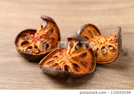 Dried Bael fruit on wooden background, Herbal drink ingredient 119059299