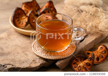 Bael fruit herbal drink in cup glass on wooden background, Healthy drink 119059300