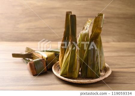 Thai dessert, Steamed rice flour stuffed with sweet coconut wrapped in banana leaf 119059334